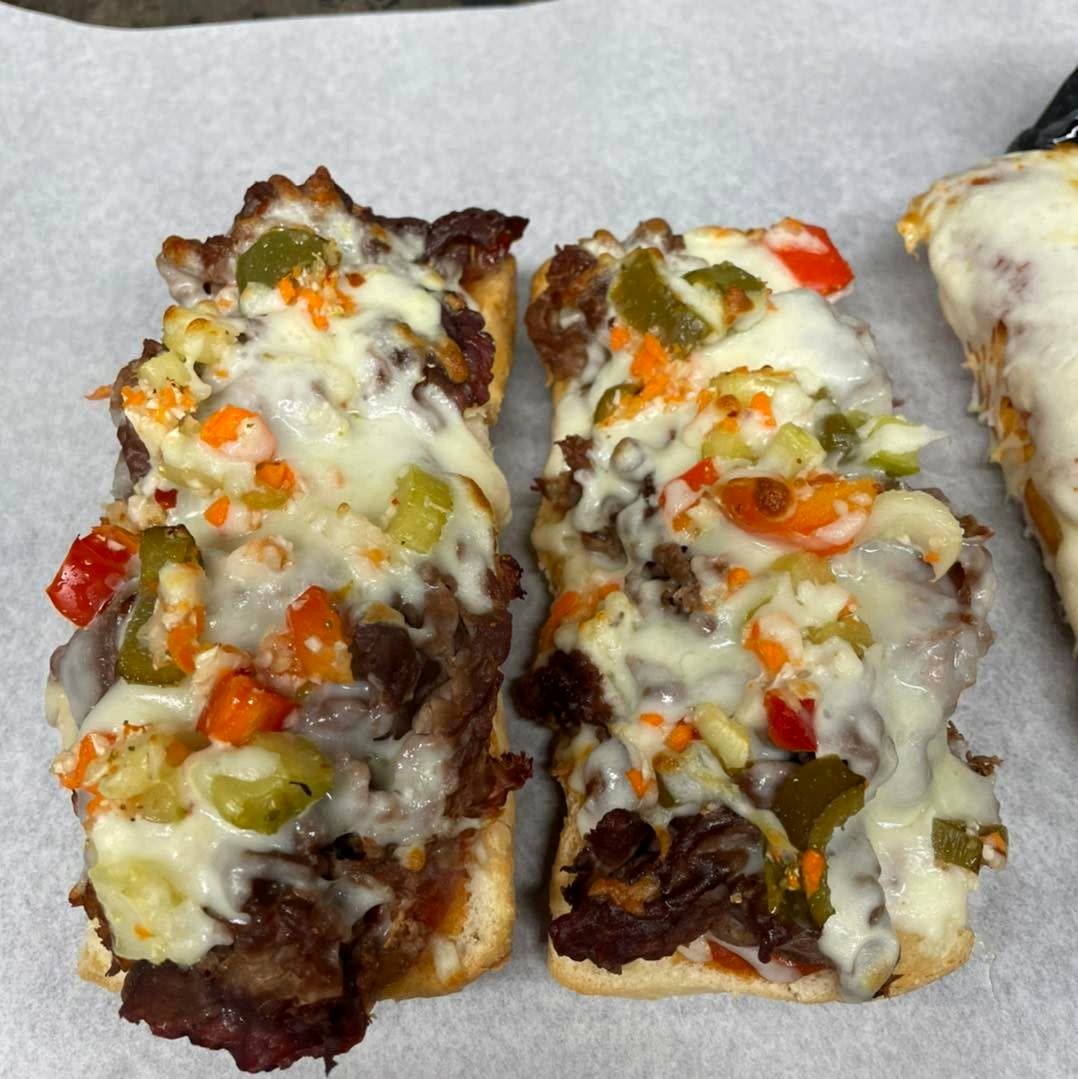 Melted cheese and beef subs covered in giardiniera